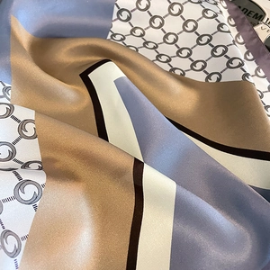 Elegant silk scarf with geometric color blocks and chain pattern in satin finish