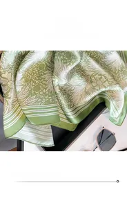 Detail shot of the fine edge stitching on silk square scarf with floral pattern