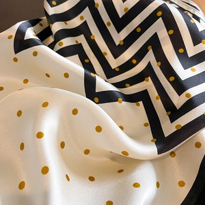 Polka dot silk square scarf with classic black zigzag patterns and golden accents