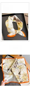 Détail de foulard en soie avec motif magnolia jaune et bords roulottés orange