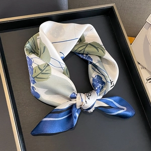 Elegant mulberry silk scarf with blue grape pattern and green leaves on black tray