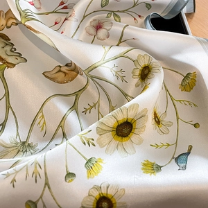 Elegant silk scarf featuring rabbit and floral prints with soft satin texture and drape