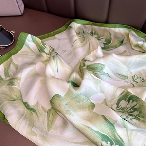 Elegant white and green floral silk scarf with a glossy finish and emerald rolled edges
