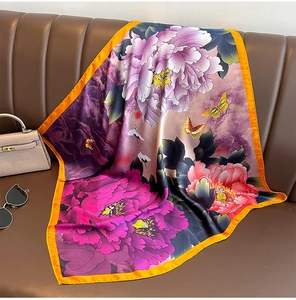 Detailed close-up of silk square scarf featuring vibrant peony and crane print
