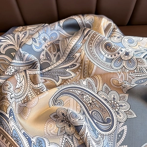 Elegant paisley patterned silk scarf for women featuring a retro blue and khaki floral design