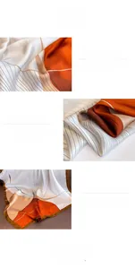 Detail of digital printed silk scarf featuring orange blocks and double-edged hem stitching