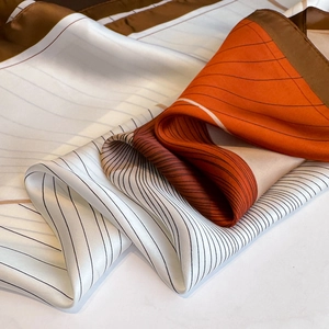 Minimalist silk square scarf with geometric stripes in orange and brown tones