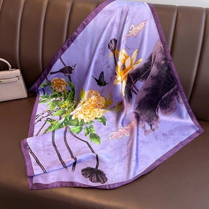 Lavender purple silk scarf with floral peony and magpie print on a leather background