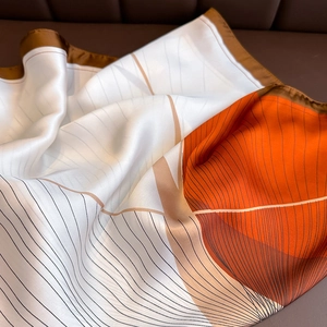 Minimalist silk square scarf with geometric orange patterns and fine black lines