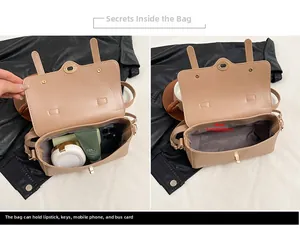 Vista dettagliata dello spazioso scomparto interno della borsa a tracolla beige retrò