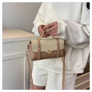 Dettaglio borsa in pelle kaki con patta intrecciata beige e chiusura a girello oro