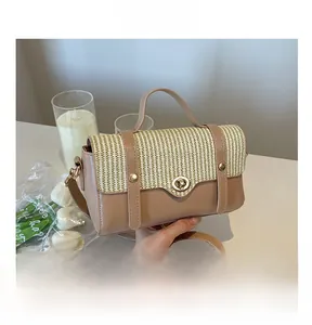 Detail of vintage hand-held bag with woven texture, leather panels and gold twist lock