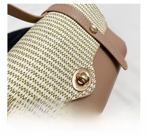 Close-up of golden twist lock and beige woven texture on luxury leather handbag