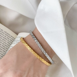 Quilted motif titanium steel bangles in gold and silver finish for a luxury look