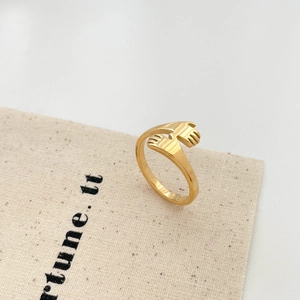 Detailed view of an 18K gold plated hands hug ring with an adjustable open band design