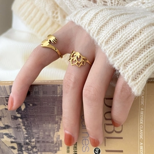 18K gold plated ring set featuring hollow lotus and hugging hands on model hand