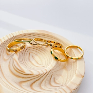 Set of 7 gold titanium steel rings with green crystals and micro-pave diamonds