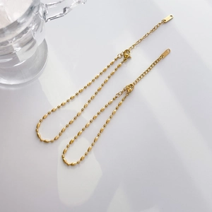 Detail of 18k gold plated titanium chain with oval beads and K18 hallmark stamp