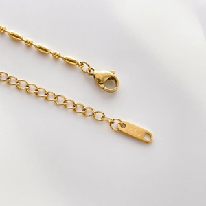 Detail of 18K gold plated lobster clasp and K18 hallmark on the adjustable link chain