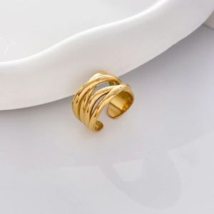 Close-up of gold plated stainless steel layered crisscross ring with polished finish