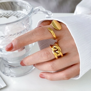 Detailed close-up of a three-piece gold-plated titanium steel ring set worn on a hand
