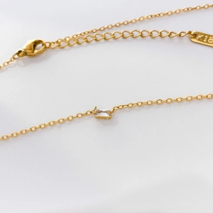 Detailed macro view of 18K gold chain with lobster clasp and K18 engraving hallmark