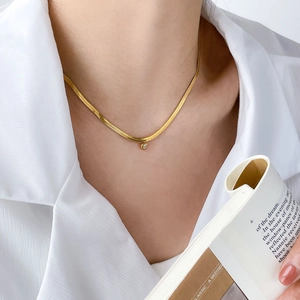 Minimalist gold snake bone chain necklace with a round sparkling zircon pendant for women