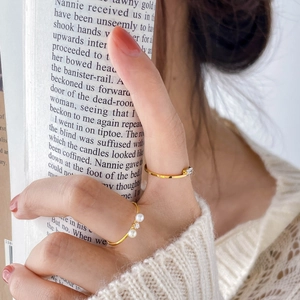 Elegant gold freshwater pearl and zircon twist rings shown on model for a refined look