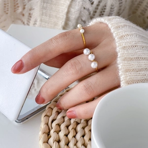 Elegant gold twisted ring with fresh water pearls shown on model in warm setting