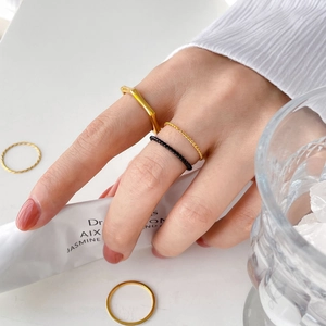 Minimalist gold and black twisted rope rings set with geometric square signet design