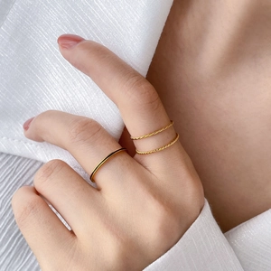 Minimalist gold-plated hexagon ring set with black enamel detail on female model