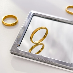 Macro view of 18K gold titanium steel ring featuring delicate vertical carved textures