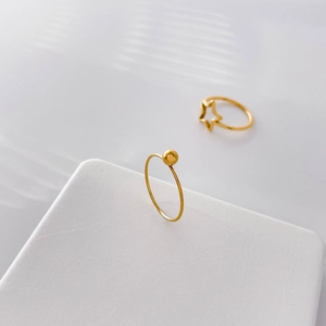 Detailed macro view of 18k gold plated stainless steel ring with hollow star design