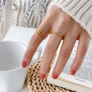 Detail of minimalist 18K gold plated titanium ring with cute cat and rabbit ear designs