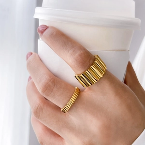 Set of two gear-style 18K gold plated titanium rings with vertical ribbed texture