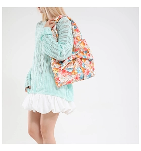 Large floral pattern tote bag featuring a decorative side bow and wide shoulder strap