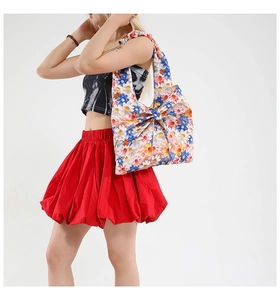 Detailed shot of large floral tote bag featuring a prominent decorative bow on the front