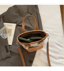 Top view of cream and tan bucket bag showing spacious interior with zip pocket and phone