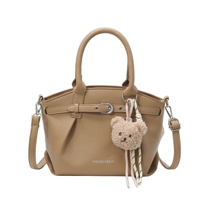 Brown lychee texture bucket bag with crossbody strap and cute plush bear charm