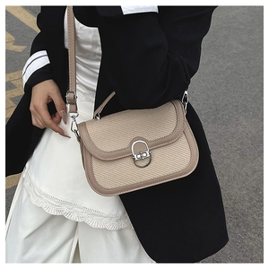 Detail of khaki and beige crossbody bag with horseshoe lock and woven texture