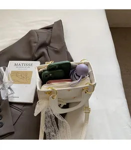 Detail of white daisy embroidered bag interior showing capacity for phone and umbrella
