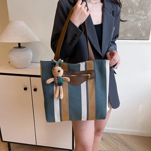 Large striped canvas tote bag with front leather pocket and plush bunny pendant for women