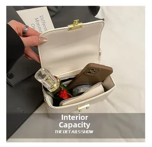 Top view of the white square bag interior showing capacity for phone and cosmetics
