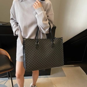 Retro grey monogram tote bag with black leather handles for stylish women commute