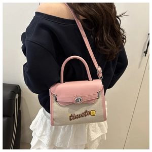 Detail of pink leather and beige canvas Kelly bag with embroidered cartoon character