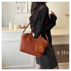 Detail of vintage brown patterned tote bag with adjustable strap and small coin purse