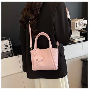 Pink lychee texture leather bucket bag with cute elephant charm and thin shoulder strap