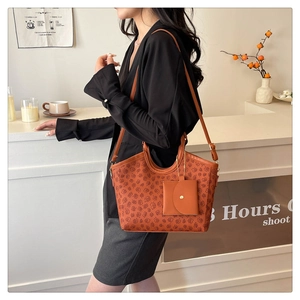 Close-up of caramel vintage monogram tote bag with matching pouch and shoulder strap