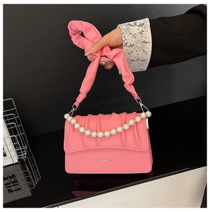 Detail of pink pleated handbag with pearl chain and Fashion & Bags text print