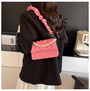 Fashionable bright pink pleated crossbody bag with pearl chain detail and ruffles